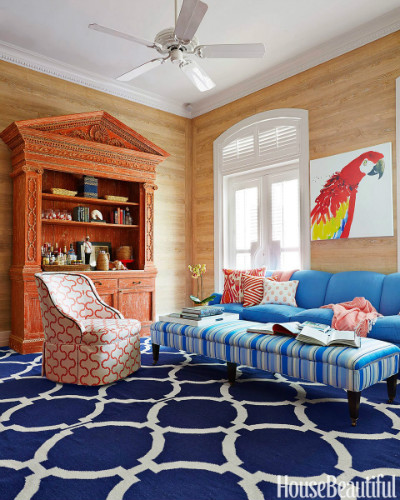 tapete azul e branco com sofa azul claro e quadro de arara vermelha