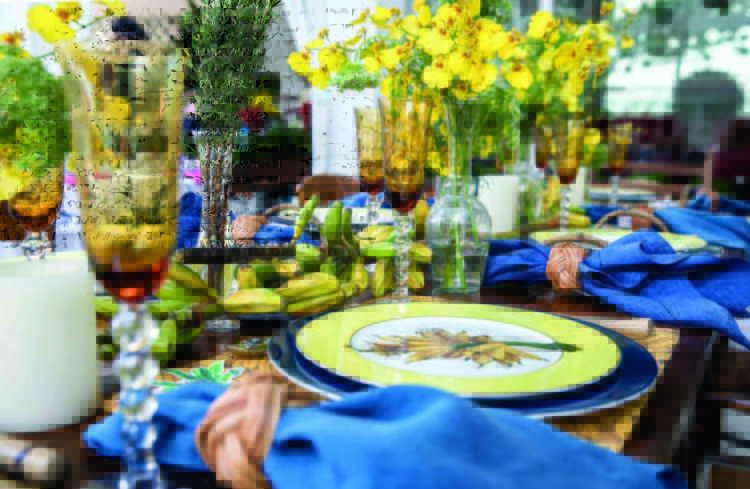 Inspirações para se criar mesas caprichadas, mesa com louça com desenhos de banana e decorada com flores amarelas