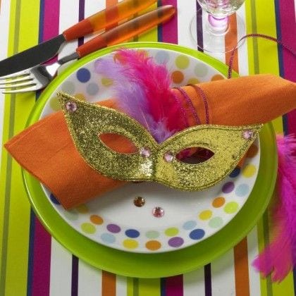 Ideias de decoração de Carnaval para festejar em casa, uma mascara enfeitando o guardanapo.