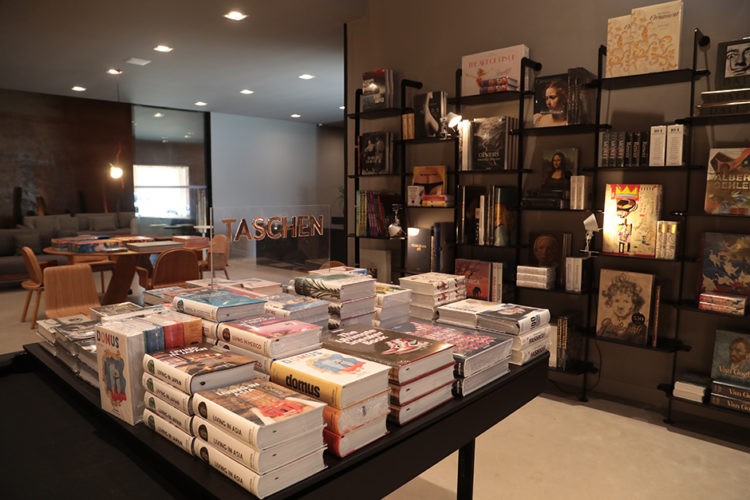 Abertura da exposição "Taschen 40", na loja da Mula Preta. Mesa quadrada repleta de livros da editora