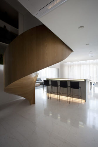 Escada helicoidal em madeira carvalho, mas parece uma escultura na canto da sala.