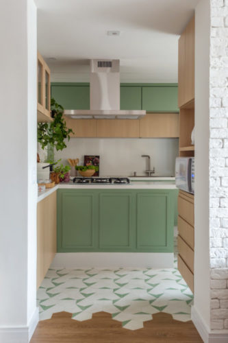 70m2 em Icaraí, com décor feminino, colorido e alegre. Cozinha com armários na cor verde menta, piso da cozinha em ladrilho hidráulico nas cores verde menta e branco se mescla com o piso vinilico na transição de ambientes, sala para cozinha