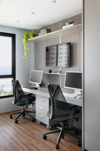 Home office na bancada branca com dois lugares, duas cadeiras e dois computadores