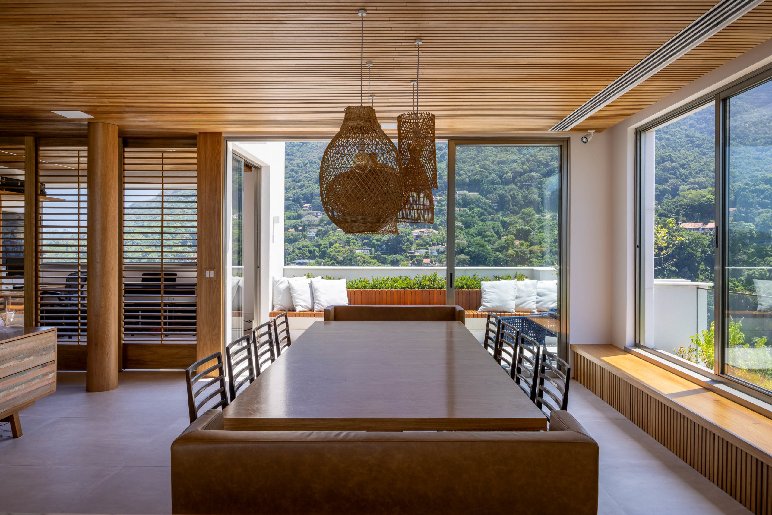 Família troca apartamento por cobertura no mesmo prédio, mas reproduz planta e décor do antigo em reforma tocada por Mauricio Nóbrega. Sala de jantar no segundo andar da cobertura, com vista para a praia e a Pedra da Gávea, no Rio de Janeiro.