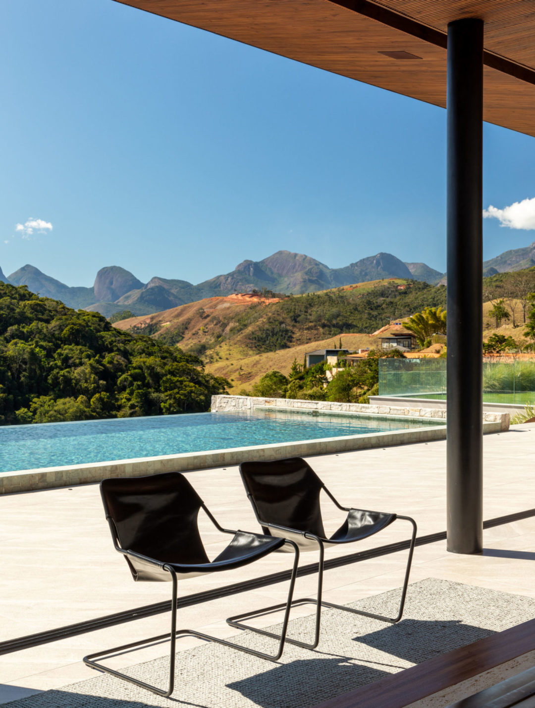 Localizada em Itaipava (distrito de Petrópolis, RJ), esta casa de campo é um refúgio moderno integrado à natureza. Na decoração, de estilo contemporâneo despojado, tudo é novo. Os arquitetos priorizaram móveis modernos e atuais assinados por designers brasileiros, com traços simples e atemporais, que ‘conversam’ com a arquitetura da casa, a exemplo das poltronas Paulistano, de Paulo Mendes da Rocha.