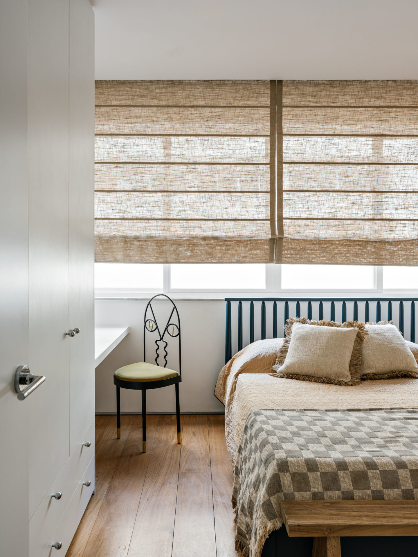 quarto de hóspedes com cama, janela e uma cadeira