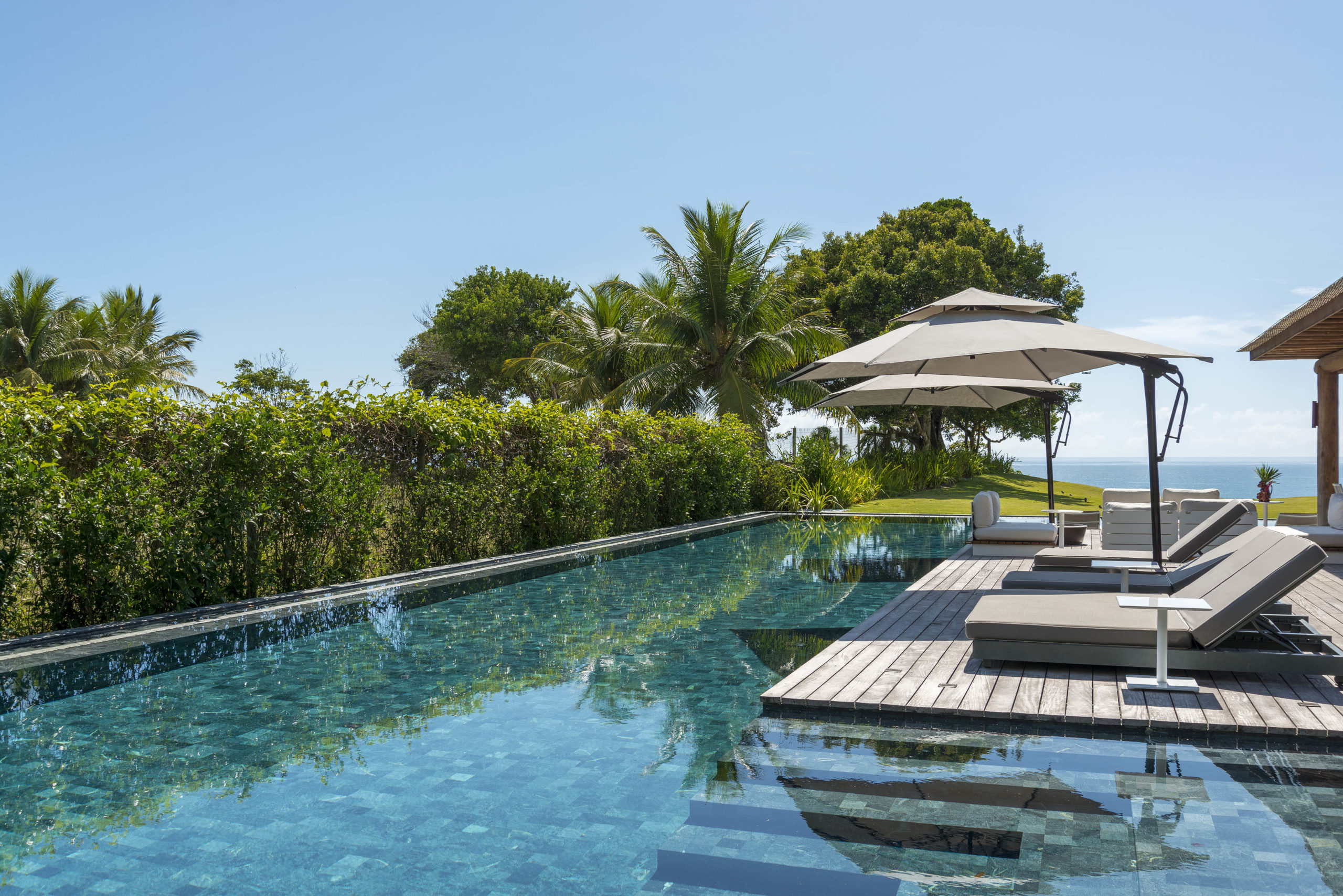 piscina e deck com ombrelones