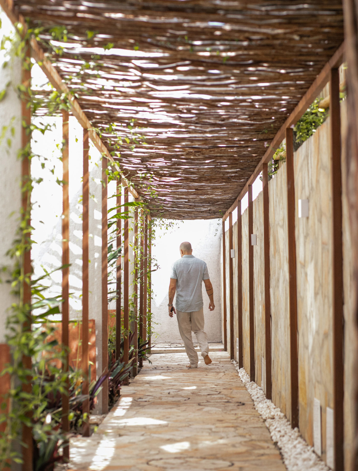 na foto um homem passa por dentro um túnel dentro de uma casa