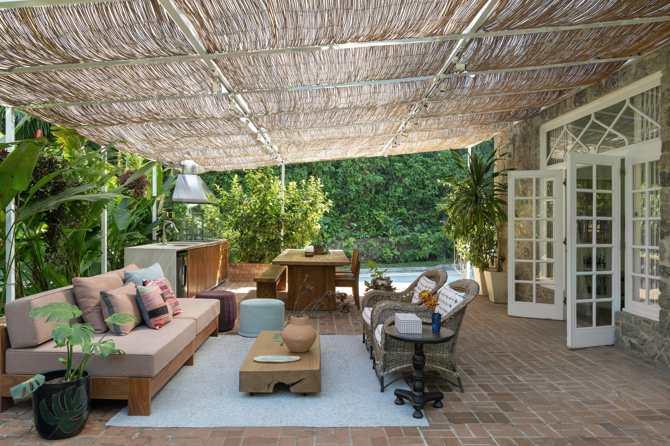 na foto varanda gourmet de casa dos anos de 1940 com sofá, churrasqueira e mesa