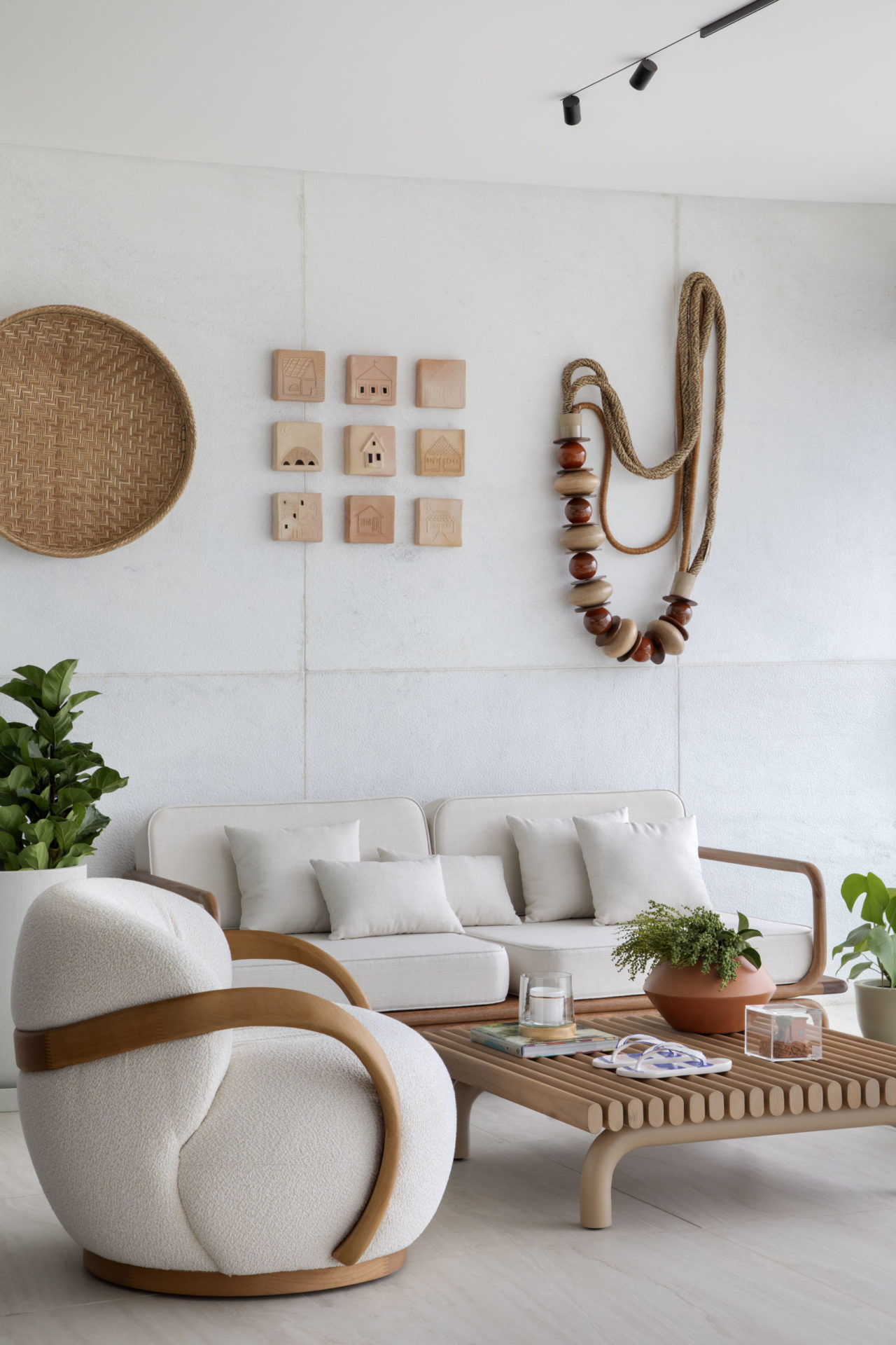 na foto sala com sofá branco, poltrona branca e cerâmicas