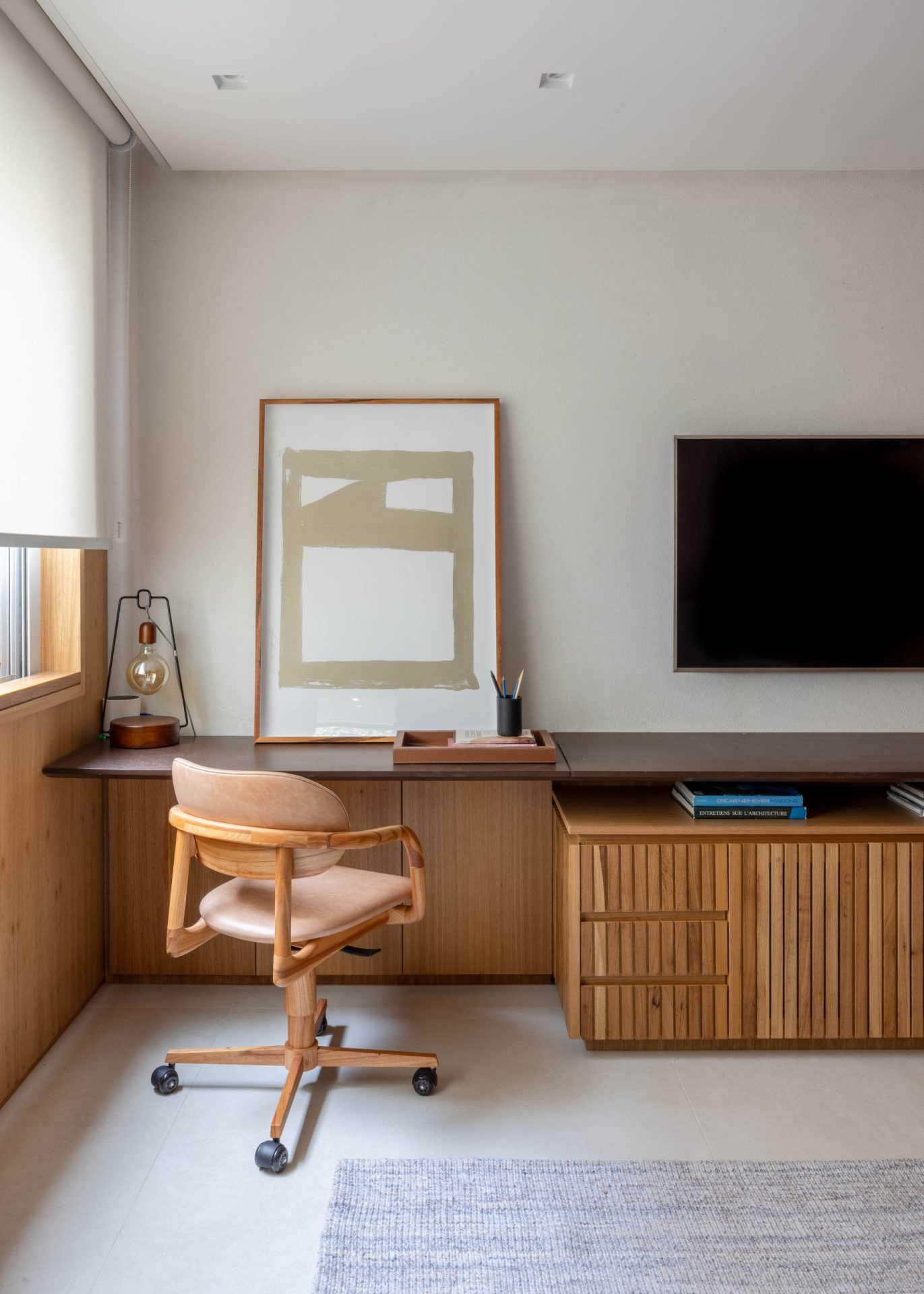 na foto escritório de cobertura duplex com tv na parede e mesa de trabalho. parede branca,